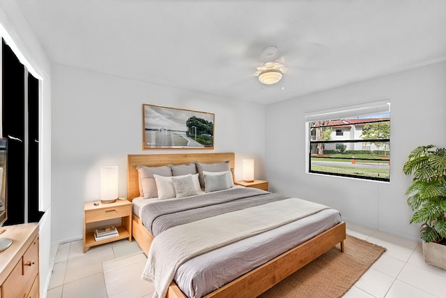 bedroom with ceiling fan and light tile patterned flooring