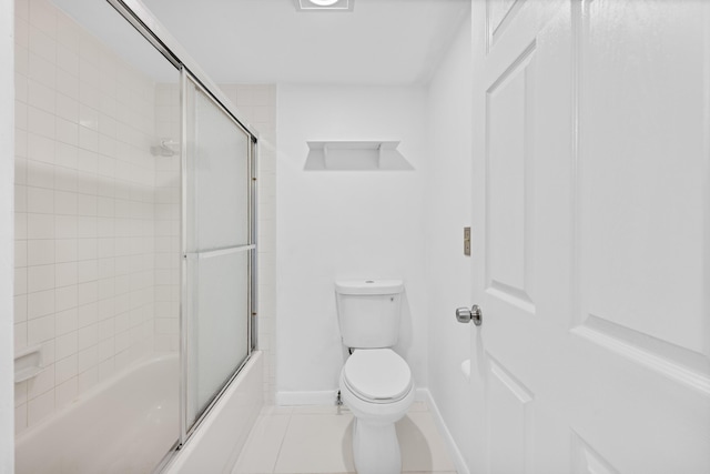 bathroom with tile patterned floors, enclosed tub / shower combo, and toilet