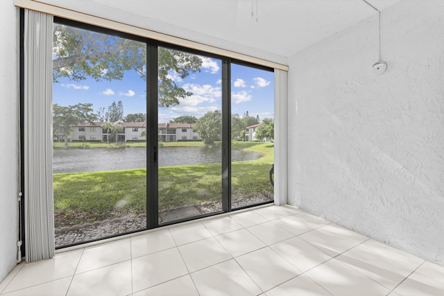 unfurnished sunroom with a water view and a healthy amount of sunlight