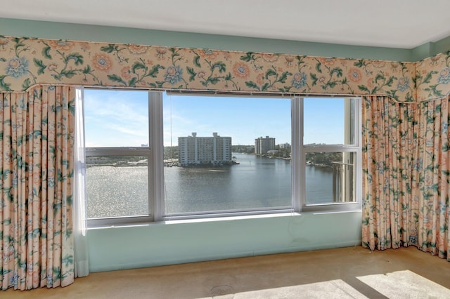 interior space with a water view and carpet floors