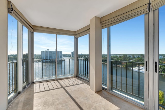 unfurnished sunroom with a water view