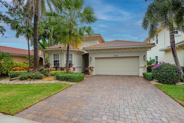 mediterranean / spanish-style house with a garage