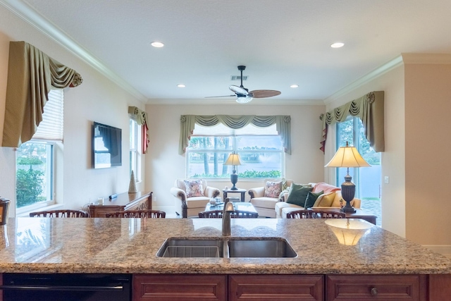 kitchen with plenty of natural light, black dishwasher, sink, and crown molding