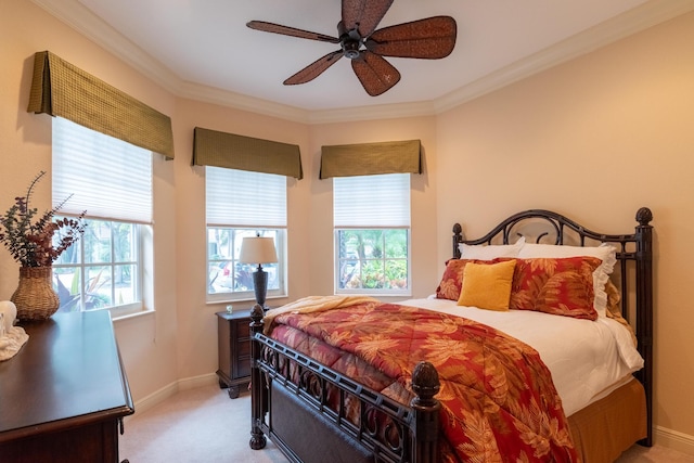 bedroom featuring ceiling fan, crown molding, and light carpet