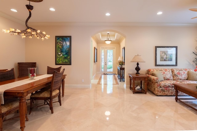 dining space with ornamental molding and a notable chandelier