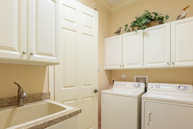 washroom featuring separate washer and dryer, crown molding, sink, and cabinets