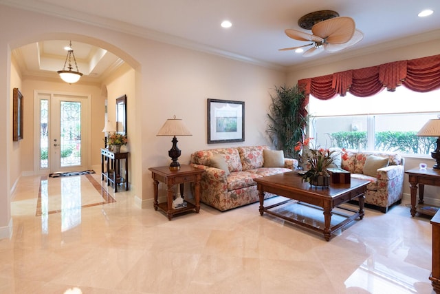 living room with ceiling fan and crown molding