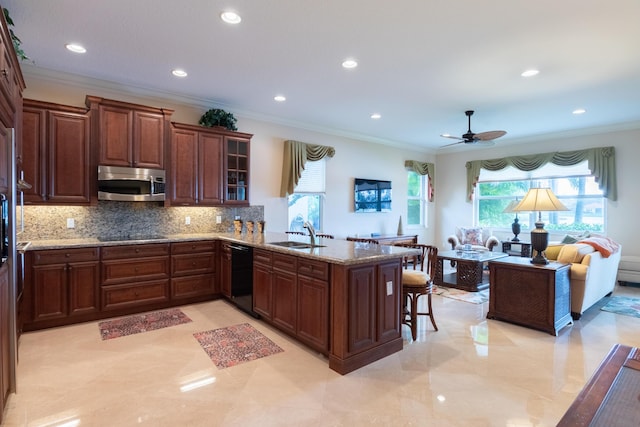 kitchen with sink, backsplash, kitchen peninsula, a breakfast bar area, and black appliances