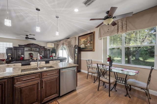 kitchen featuring a wealth of natural light, dishwasher, light wood-type flooring, and sink