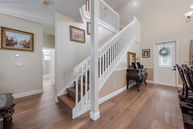 stairway with hardwood / wood-style floors