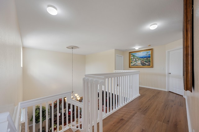 hall featuring a chandelier and wood-type flooring