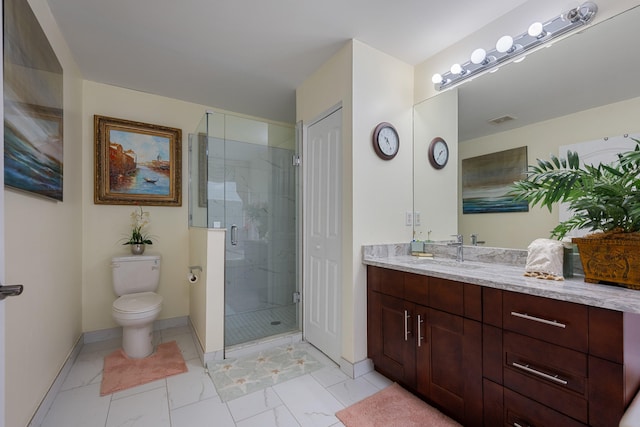 bathroom with vanity, toilet, and an enclosed shower