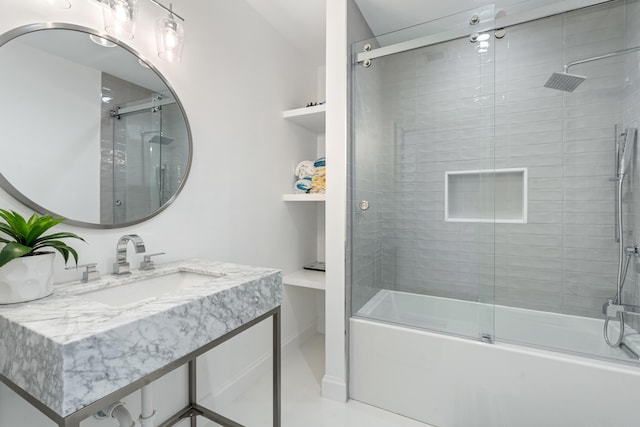 bathroom featuring vanity and shower / bath combination with glass door