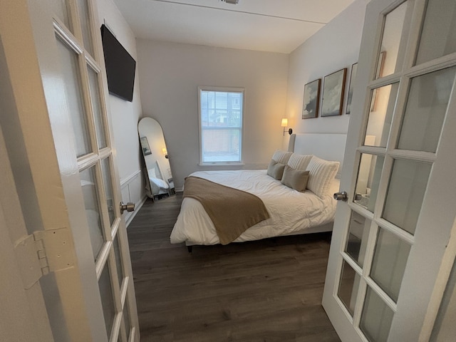 bedroom featuring dark hardwood / wood-style floors and french doors