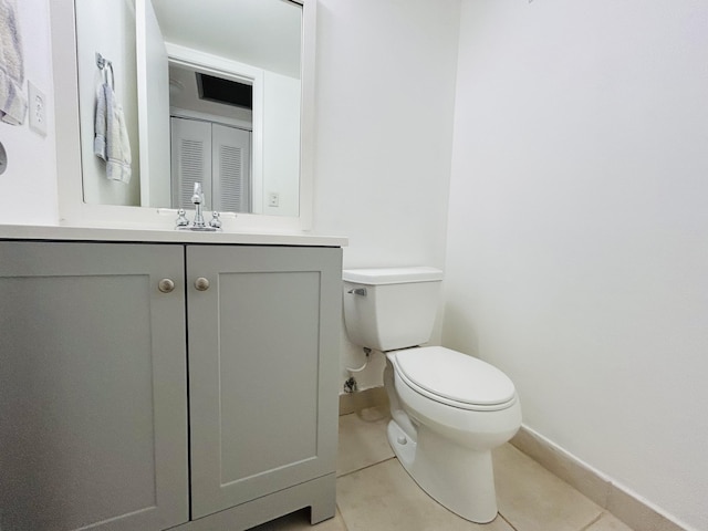 bathroom featuring tile patterned floors, vanity, and toilet