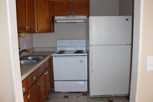 kitchen featuring white appliances and sink