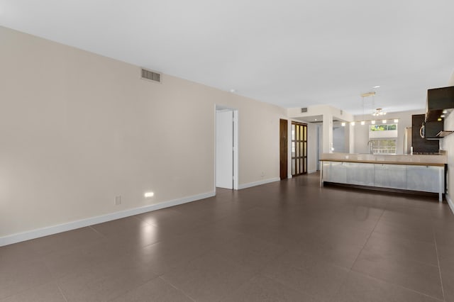 unfurnished living room with dark tile patterned flooring