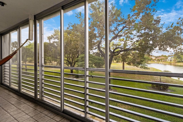 unfurnished sunroom featuring a water view