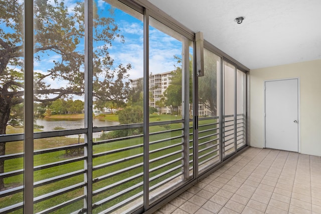 unfurnished sunroom with a water view