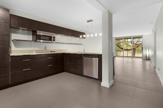 kitchen with light tile patterned floors, stainless steel appliances, and sink