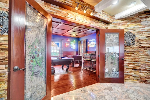 interior space featuring beam ceiling, pool table, and hardwood / wood-style floors