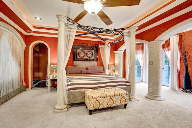 bedroom featuring a raised ceiling, ornate columns, carpet flooring, and ornamental molding