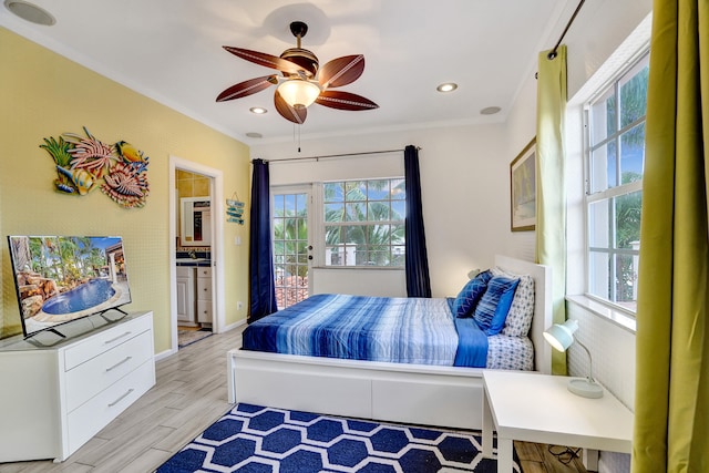 bedroom with multiple windows, crown molding, access to outside, and light wood-type flooring