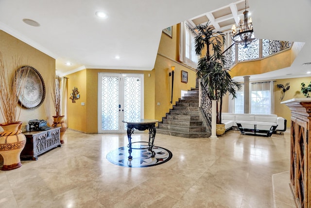 entryway featuring plenty of natural light, crown molding, french doors, and coffered ceiling