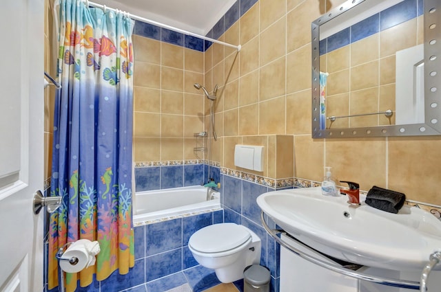 full bathroom featuring toilet, tile walls, backsplash, shower / tub combo with curtain, and vanity