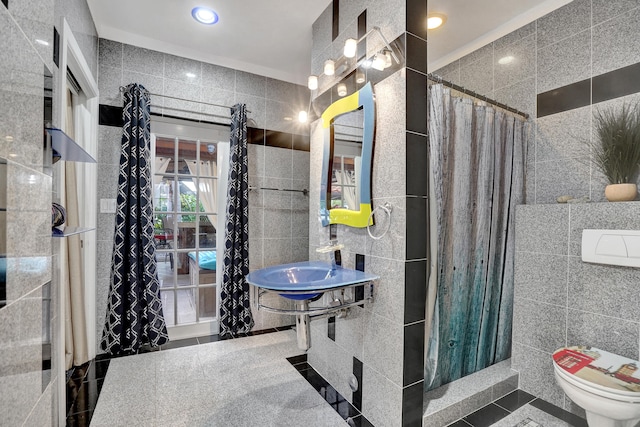 bathroom featuring tile walls, a shower with curtain, and toilet