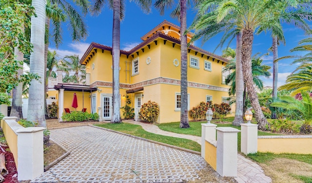 mediterranean / spanish house featuring a balcony