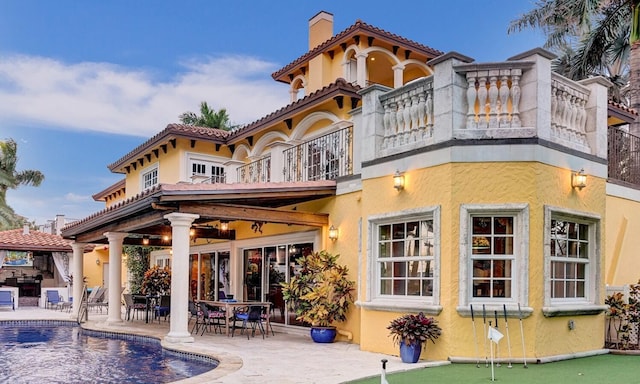 back of property with a patio, a balcony, and a gazebo