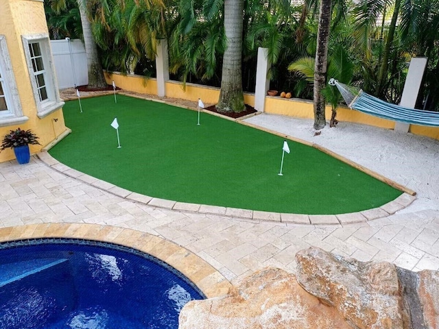 view of property's community featuring a patio area and a pool