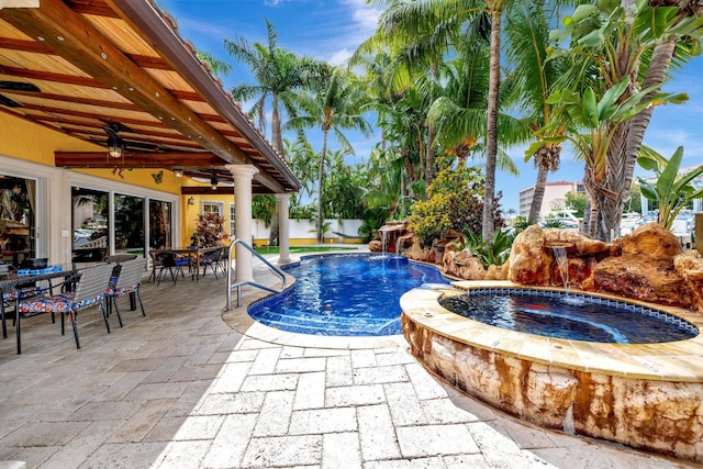 view of pool with pool water feature, an in ground hot tub, ceiling fan, and a patio area