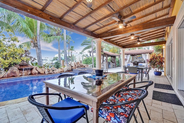 view of patio / terrace with a pool with hot tub, a gazebo, and ceiling fan