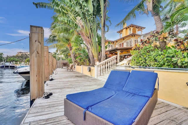 wooden terrace featuring a water view