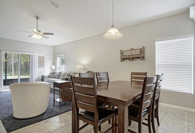 dining space with ceiling fan and light tile patterned floors