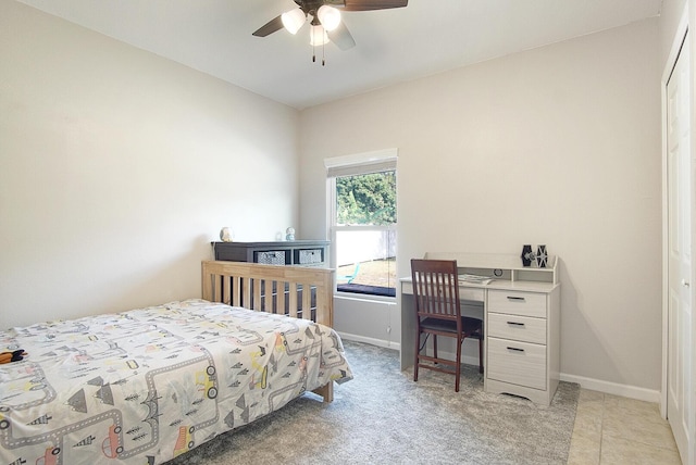 carpeted bedroom featuring ceiling fan and a closet