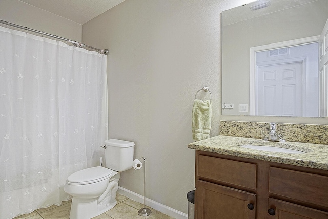 bathroom featuring tile patterned floors, vanity, toilet, and a textured ceiling