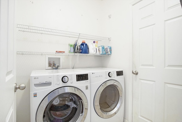 laundry area with washing machine and clothes dryer