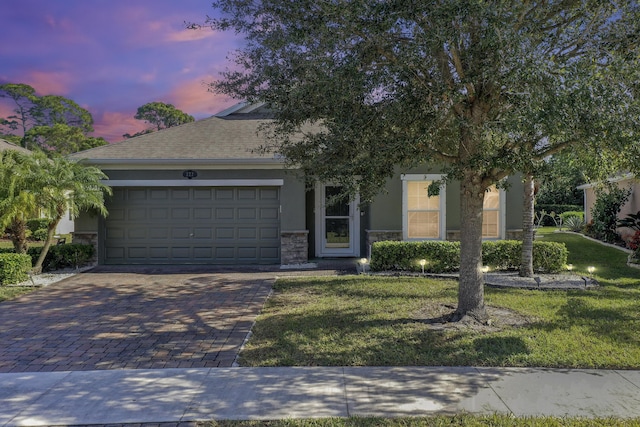 view of front facade featuring a garage and a lawn