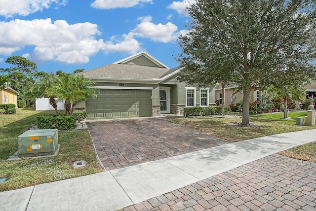 view of front of home featuring a garage and a front lawn