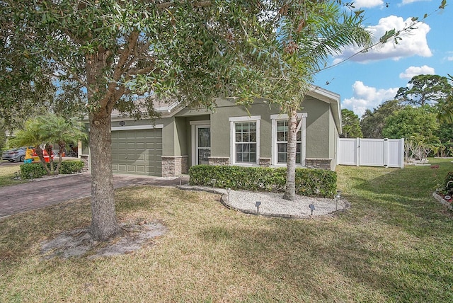 view of front of property with a garage and a front lawn