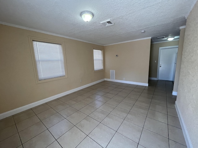 tiled spare room featuring a textured ceiling and crown molding