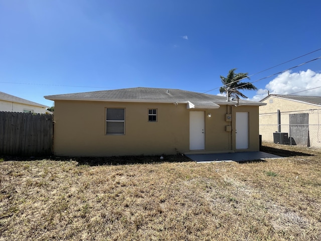 rear view of house with central AC unit