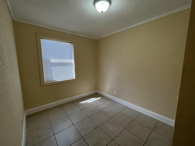 unfurnished room with light tile patterned floors, a textured ceiling, and crown molding