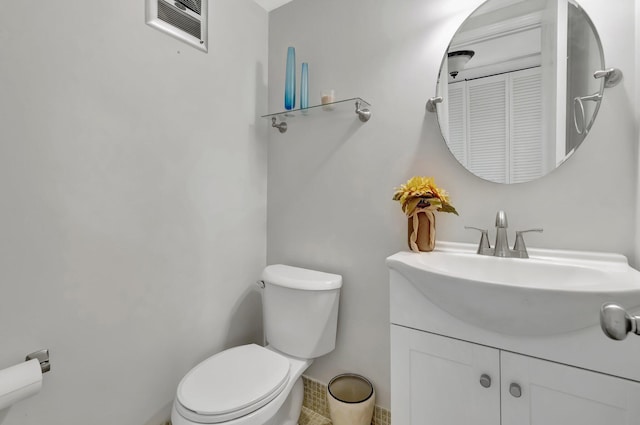 bathroom with toilet and vanity