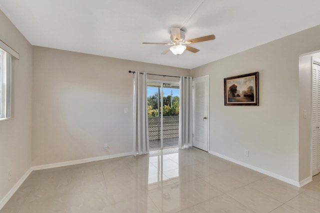 tiled empty room with ceiling fan