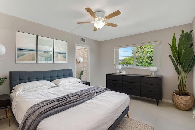 bedroom with a closet, ceiling fan, and light tile patterned flooring