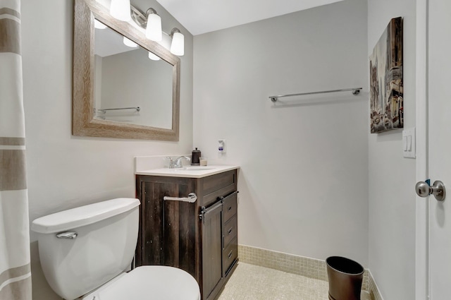 bathroom featuring toilet and vanity